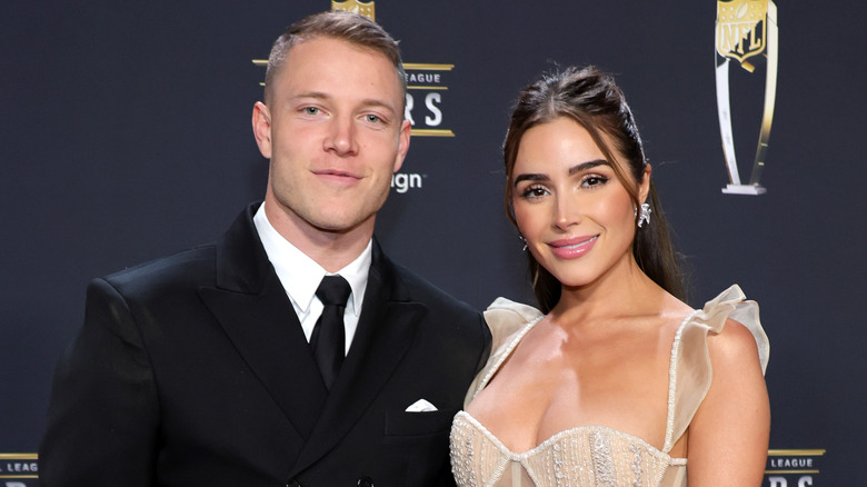 Olivia Culpo posing with Christian McCaffrey