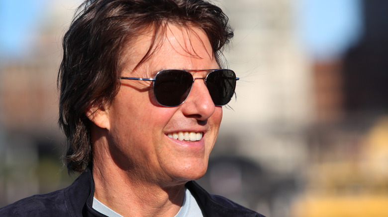 Tom Cruise attending and event and smiling