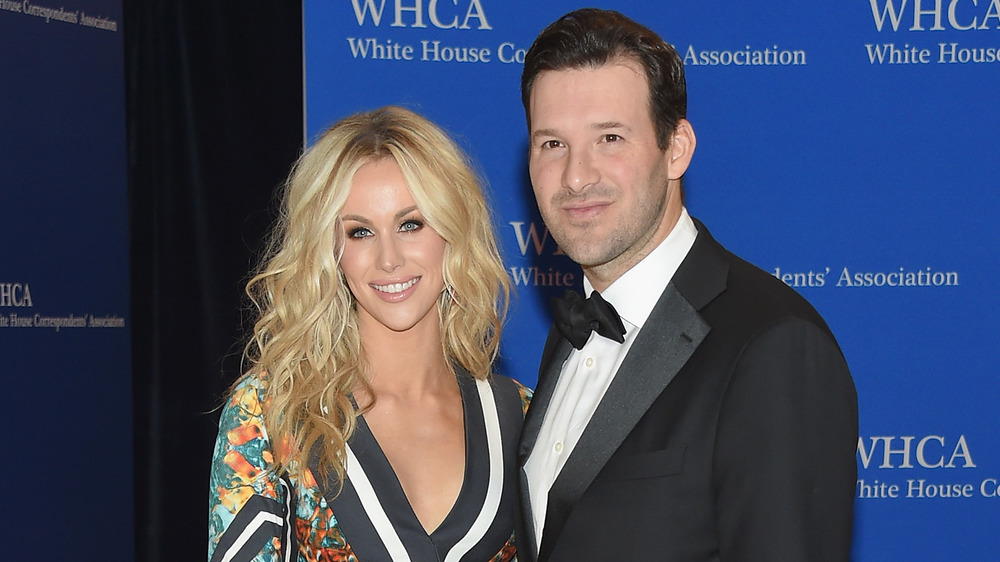 Tony Romo and his wife Candice Crawford pose together at an event