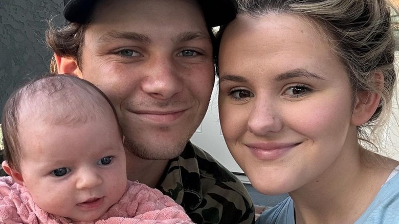 Montana Jordan and Jenna Weeks smiling with baby Emma Rae Jordan