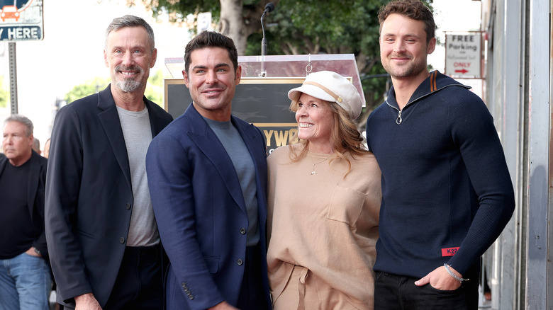 Zac Efron and Dylan Efron smiling with their parents