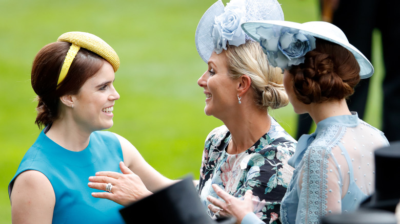 Princess Eugenie and Zara Tindall greeting each other