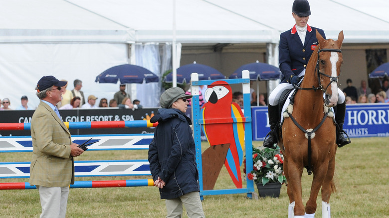 Captain Mark Phillips and Princess Anne watch their daughter, Zara Tindall, on horseback