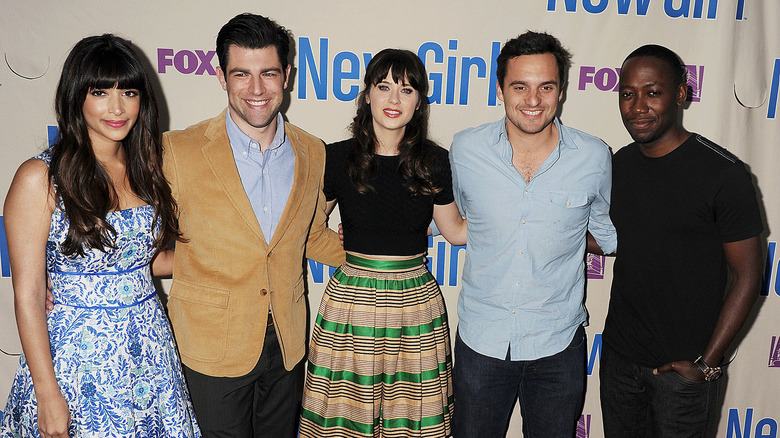 Zooey Deschanel and Jake Johnson posing with their "New Girl" co-stars