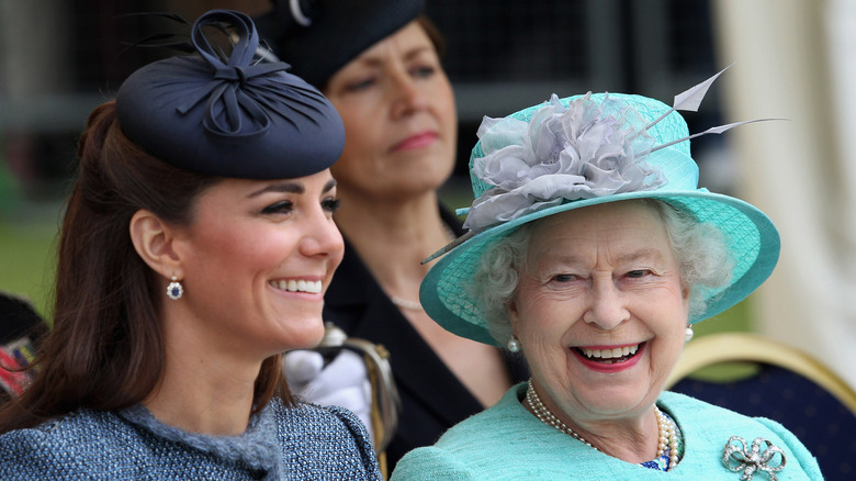 Kate Middleton and the queen smiling while watching an event