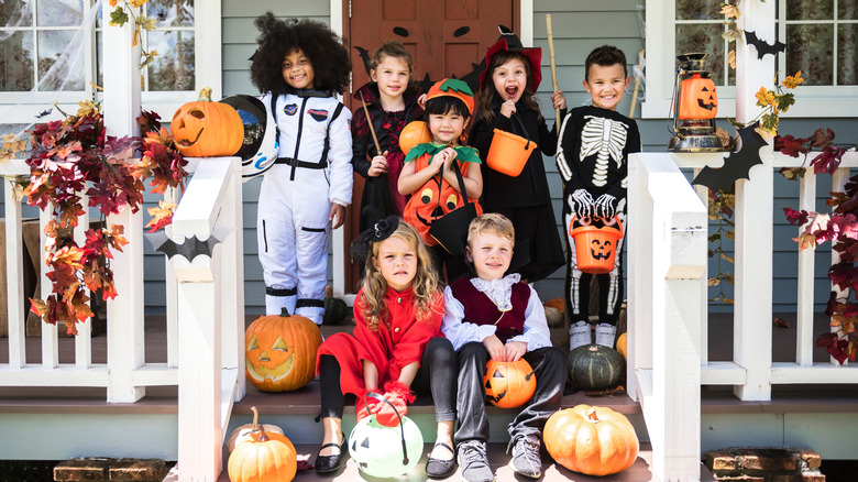 Group of children in Halloween costumes on porch