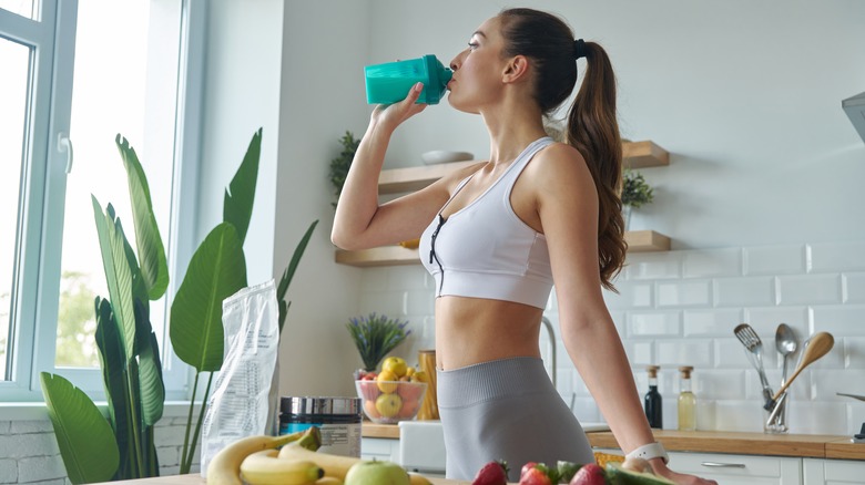 fit woman drinking a protein shake