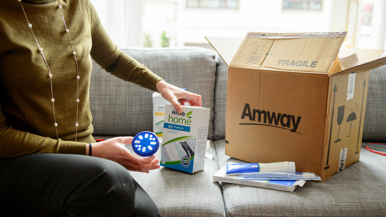 woman opening an Amway box