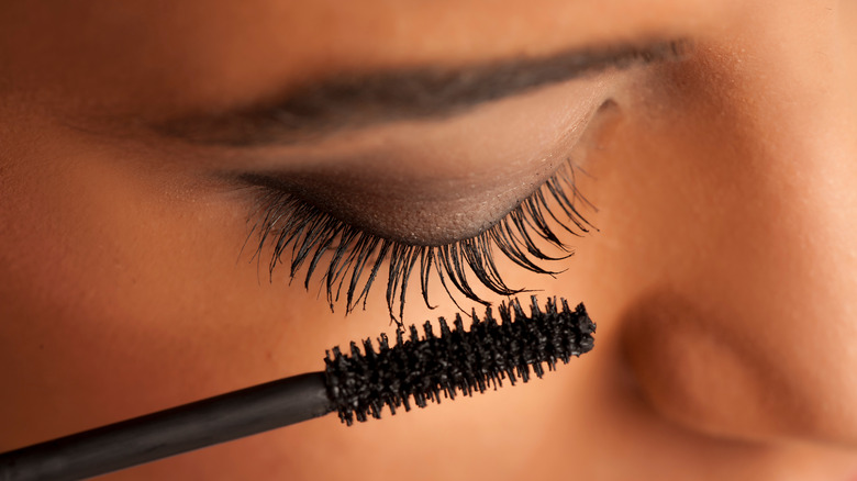 Person applying mascara