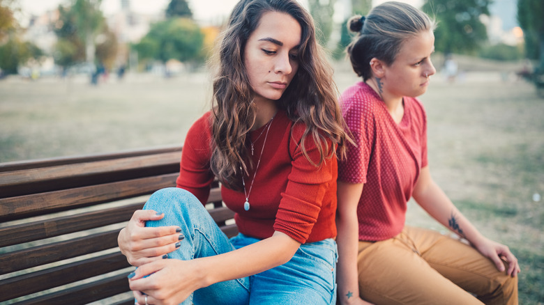 Unhappy couple sitting on bench