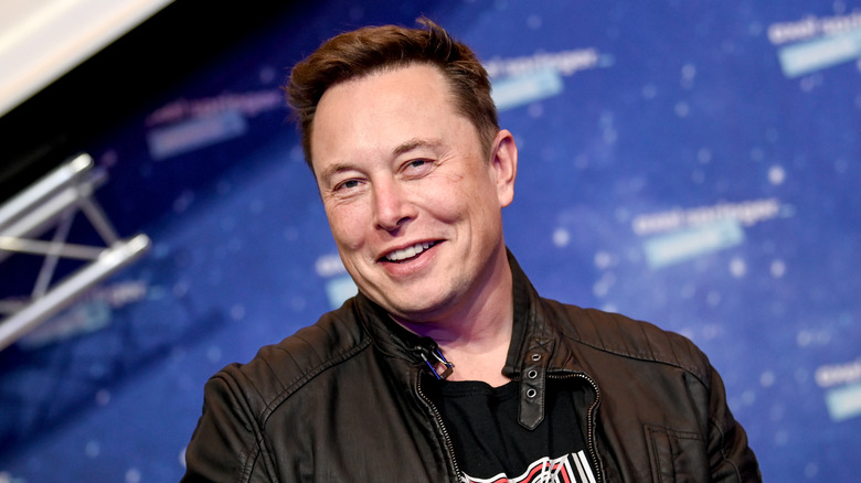 Elon Musk smiling at event 