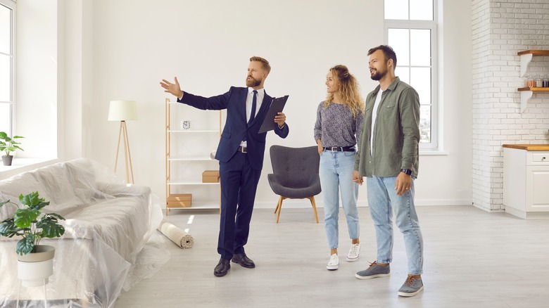 couple touring home with realtor