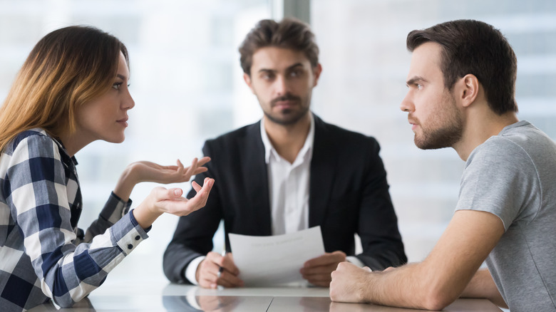 man watching arguing couple