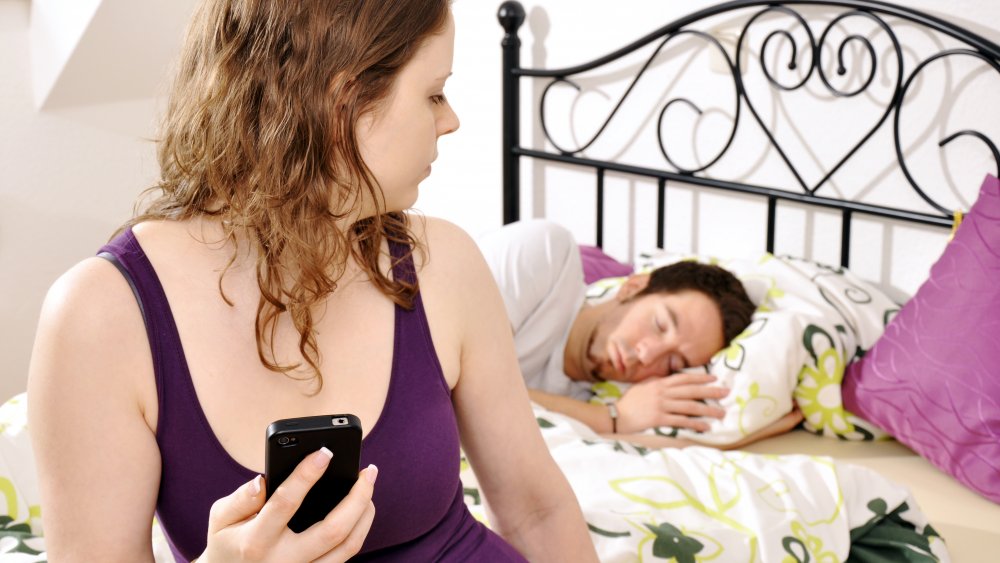 Woman reading boyfriend's phone