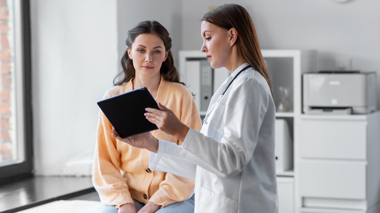 Female doctor talks to patient