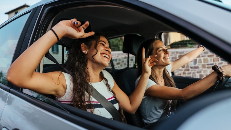 Two girls smiling in car