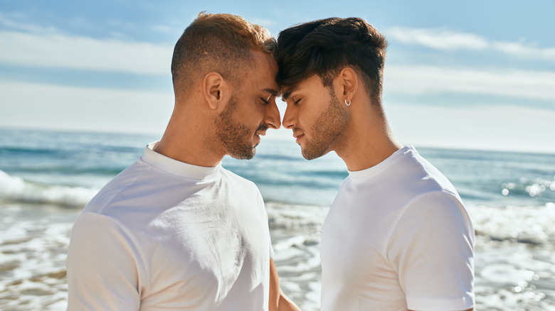 couple on beach with foreheads together