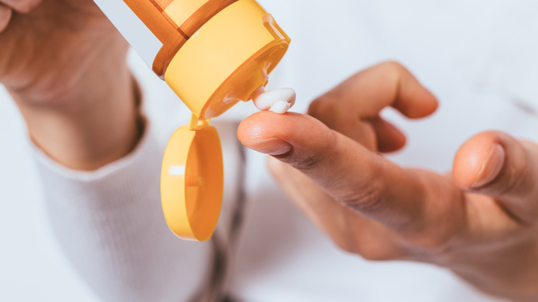 Man putting cream on finger