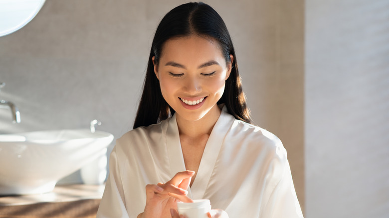 Woman applying skincare