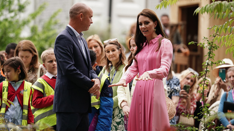 Kate Middleton talking while a group listen to her