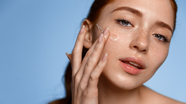 Woman applying eye cream