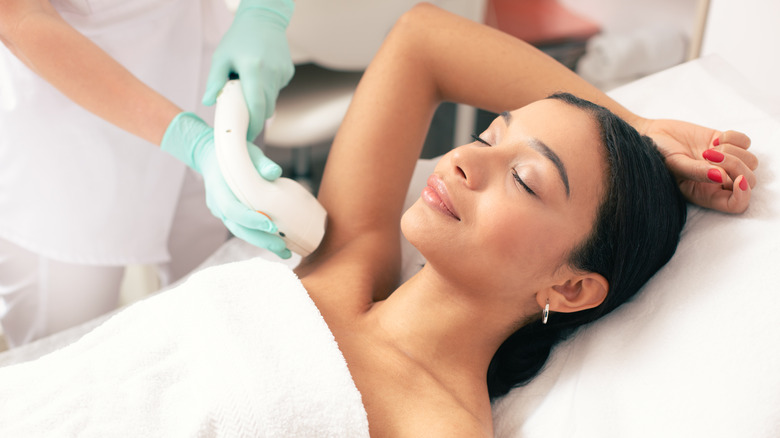 Young woman undergoing laser hair removal
