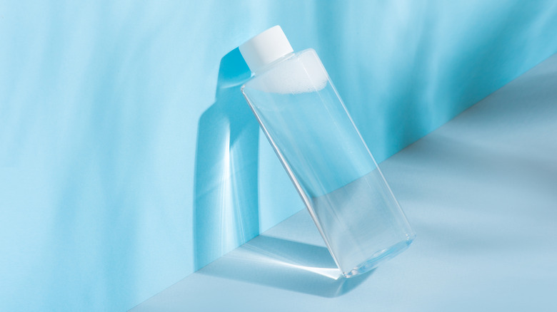 Bottle of makeup remover bottle on a blue background