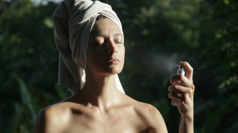 Woman using facial spray