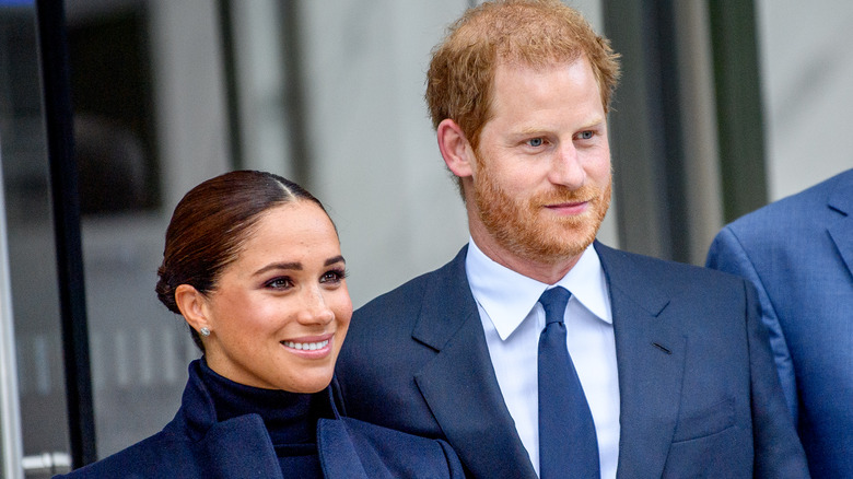 Meghan Markle and Prince Harry smiling at an event