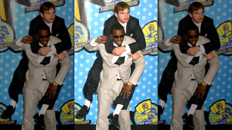 Diddy giving Ashton Kutcher a piggyback ride