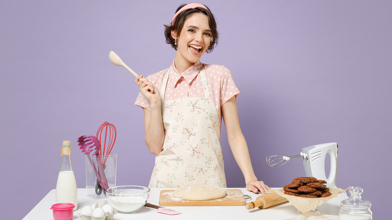 Woman making dough and smiling