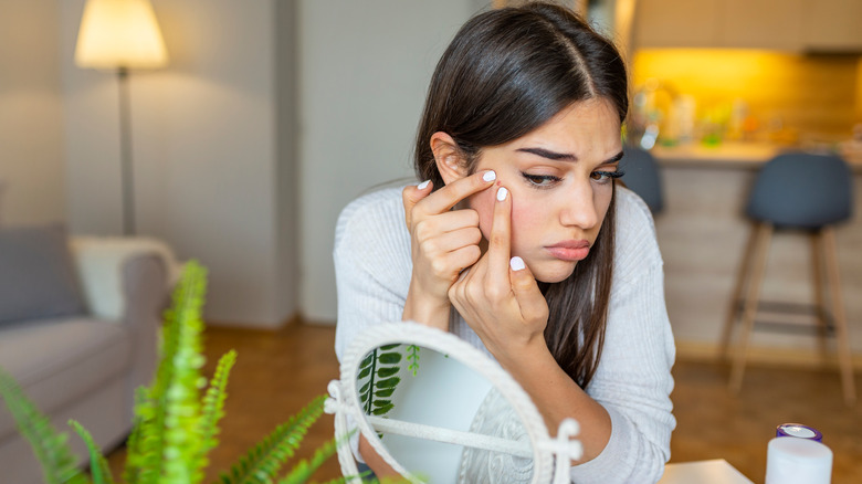 Woman popping pimples