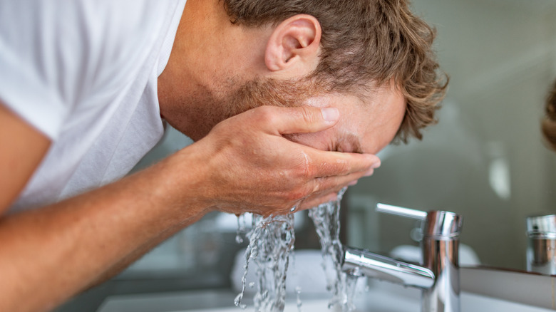 Man shaving at the sink