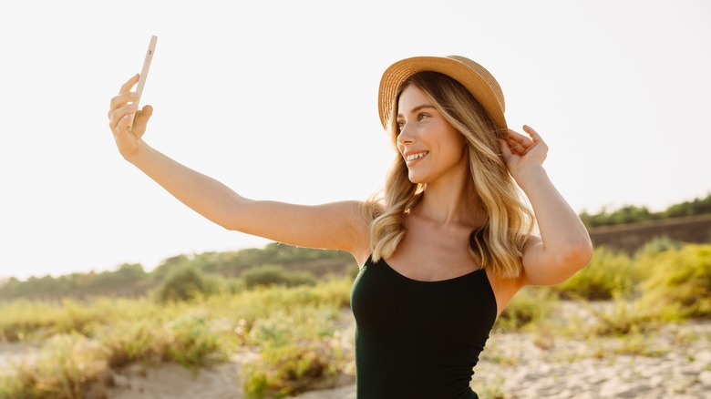 person taking selfie on beach