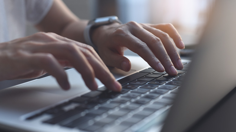 Womans hands typing on keyboard