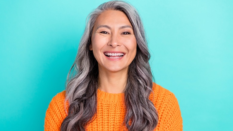 Woman with gray wavy hair smiling