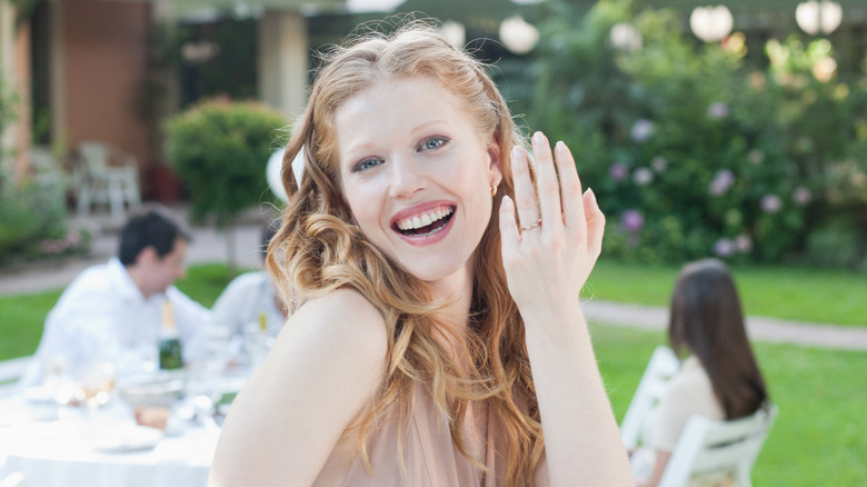 red headed woman smiling with ring