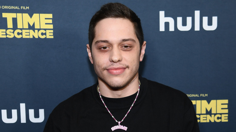 Pete Davidson with slight smile on the red carpet