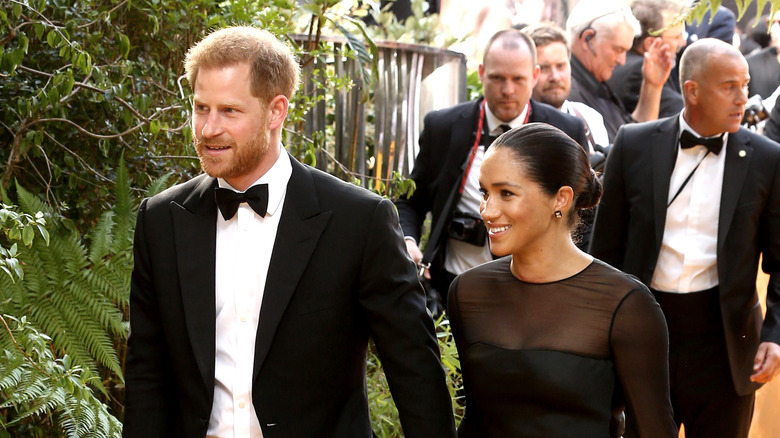 Harry and Meghan Markle walk arm-in-arm