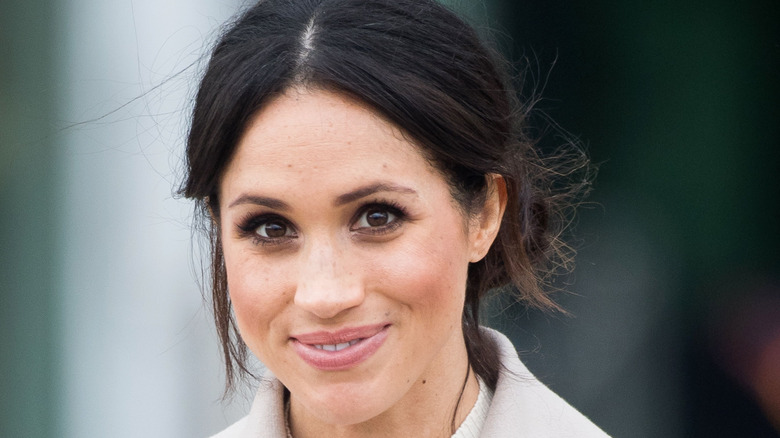 Meghan Markle smiles for the camera.