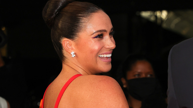 Meghan Markle laughing in red