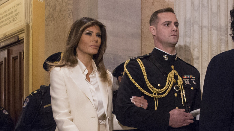 Melania Trump escorted by handsome military aide at 2018 State of the Union