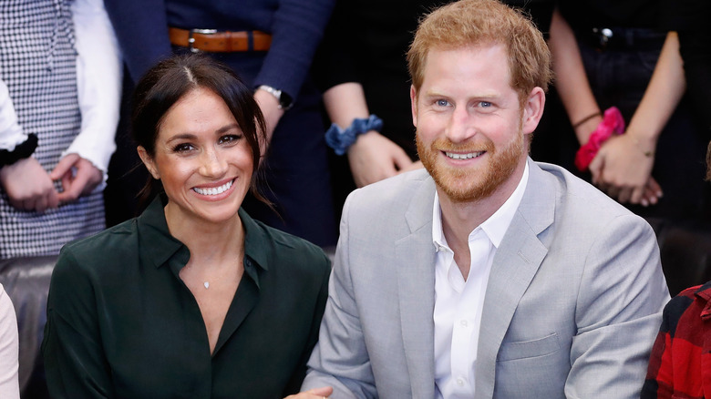 Prince Harry and Meghan Markle smile for the camera.