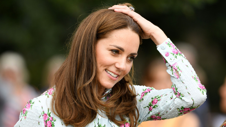 Kate Middleton fusses with her hair