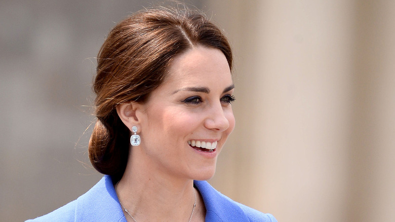 Kate Middleton posing in blue coat