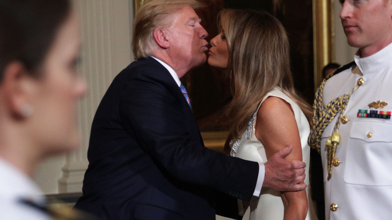 Donald and Melania Trump kiss in 2019