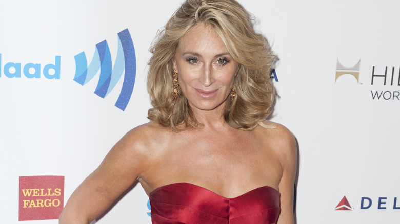 Sonja Morgan smiles in a red strapless dress.