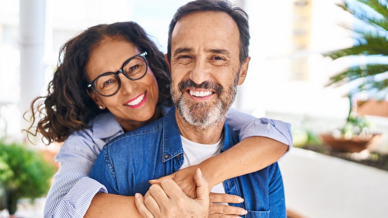 Hispanic couple hugging smiling