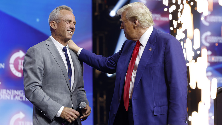 Donald Trump welcomes Robert F. Kennedy Jr. to the stage at a Turning Point Action campaign rally