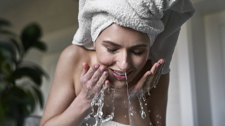 Woman washing her face